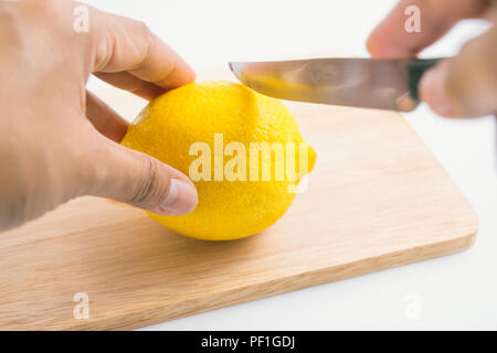 Cut fresh lemon, fresh lemon and knife on the chopping block, isolate background Stock Photo