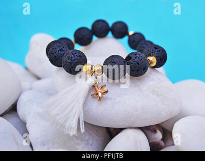 gemstone bracelet with black Lava beads and pendant starfish - volcano stones - semi precious stones jewelry Stock Photo
