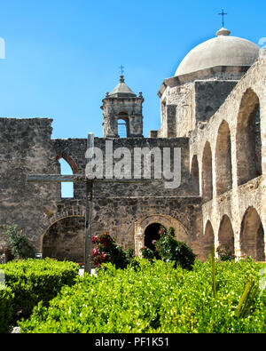 Mission San Jose San Antonio Texas View of the mission complex with bell tower, arched walls, cross, and chapel dome from the Convento. Stock Photo