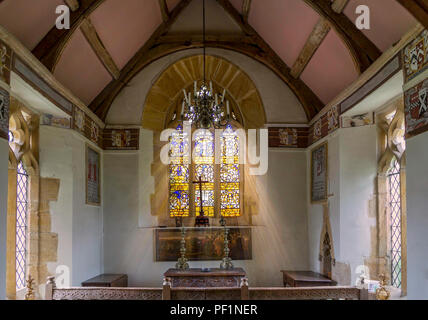 Light rays streaming through stained glass window in Church near Charlton Mackrell, Somerset, UK taken on 3 July 2013 Stock Photo