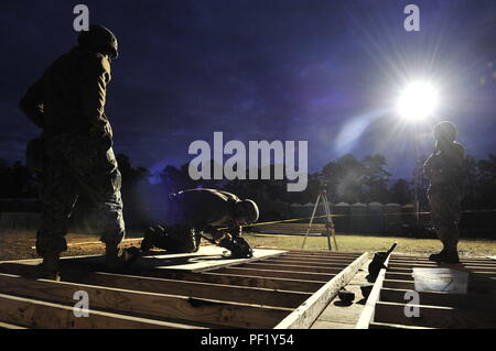 CAMP SHELBY, Miss. (Feb. 24, 2016) Seabees assigned to Naval Mobile Construction Battalion 11 construct a Southwest Asia (SWA) Hut for a graded evolution during NMCB-11 field training exercise. Upon successful completion of the exercise and final evaluation problem, NMCB-11 will become deployment ready. (U.S. Navy photo by Mass Communication Specialist 1st Class Michael C. Barton/Released) Stock Photo