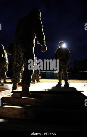 CAMP SHELBY, Miss. (Feb. 24, 2016) Builder 2nd Class Jeffrey Jutz and Builder 2nd Class Brian Kuester, assigned to Naval Mobile Construction Battalion 11, work on the walls of a Southwest Asia Hut for a graded evolution during NMCB-11 field training exercise. Upon successful completion of the exercise and final evaluation problem, NMCB-11 will become deployment ready. (U.S. Navy photo by Mass Communication Specialist 1st Class Michael C. Barton/Released) Stock Photo