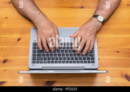 Senior man working with laptop. top view. Stock Photo