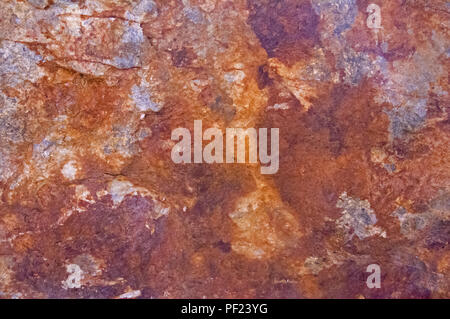 Rusty stone surface with grey, brown, and dark brown spots, Spain Stock Photo