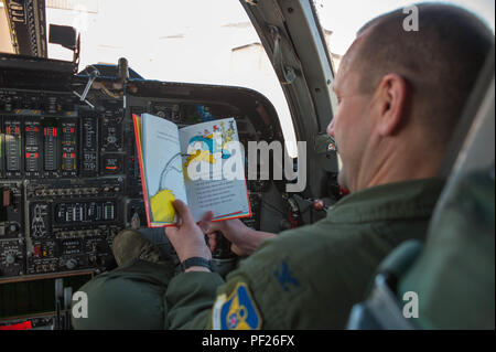 Col. Gentry Boswell, 28th Bomb Wing commander, reads a book in the flight deck of a B-1 bomber. Images were captured of Airmen reading around the base in recognition of National Read Across America Day, an observance in the United States celebrated on the school day closest to March 2, the birthday of Dr. Seuss. This day is a part of an overall Read Across America initiative, created by the National Education Association, dedicated to reading. (U.S. Air Force photo by 1st Lt. Rachel Allison/Released) Stock Photo