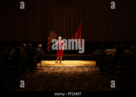 Stacie Black sings “I’m Proud to be an American” at the beginning of a professional dinner at Harrah’s Resort Feb. 25, 2016. Sergeants major, master gunnery sergeants, and master chief petty officers with I Marine Expeditionary Force came together to share and develop the leadership skills they have gained throughout their years in the Navy and Marine Corps, as well as discuss important events occurring in the nation. Black is the wife of Sgt. Maj. Troy Black, the 1st Marine Logistics Group Sergeant Major. (U.S. Marine Corps photo by Sgt. Anna Albrecht/ Released) Stock Photo