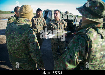 Sgt. Fernando Elias, field artillery cannoneer, Alpha Battery, 1st Battalion, 11th Marines, 1st Marine Division, describes the capabilities of the 120mm mortar round to Western Army Infantry Regiment, Japan Ground Self-Defense Force, soldiers during the Supporting Arms Coordinating Center Exercise (SACCEX) for Iron Fist 2016, aboard San Clemente Island, Calif., Feb. 21, 2016. Exercise Iron Fist 2016 provides U.S. Marines and Japanese soldiers with realistic and relevant training that enhances the planning, execution and effectiveness of combined amphibious operations. (U.S. Marine Corps photo  Stock Photo