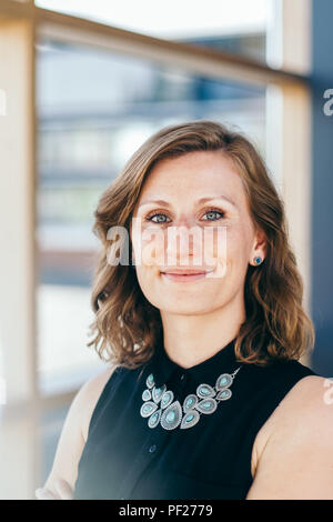 elegant and confident business woman smiles at the camera Stock Photo