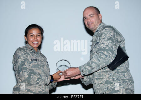 Maxwell AFB, Ala. -  Colonel Mark Allison, Judge Advocate for Air University, presents the Air Education and Training Command Outstanding Young Judge Advocate of the Year award for 2014 to Maj. Sophia Carrillo, AY-16 Air Command and Staff College student Aug. 24, 2015. (U.S. Air Force photo by Bud Hancock/Released) Stock Photo