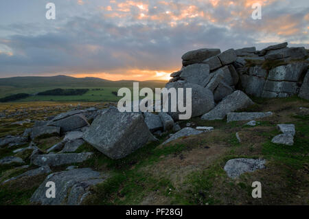 Sun setting on Higher Tor on Dartmoor in West Devon Stock Photo