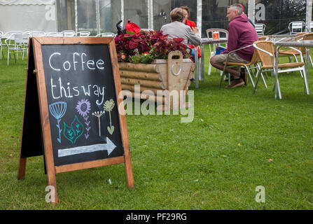 Coffee 'This Way' sign, outside eating & drinking, tables & chairs at Southport Flower Show, UK Stock Photo