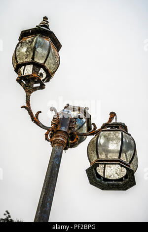 Old abandoned rusty street lanterns lost in the rain forest Stock Photo