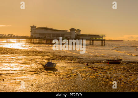 Early morning sun at low tide on a deserted beach and the Grand Pier in winter at Weston-super-Mare, North Somerset, England, UK Stock Photo