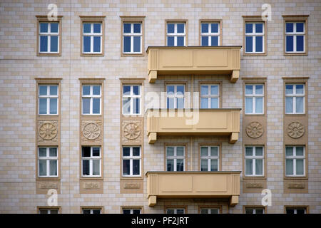 The facade of an old residential building with a clinker facade and a nostalgic balcony. Stock Photo