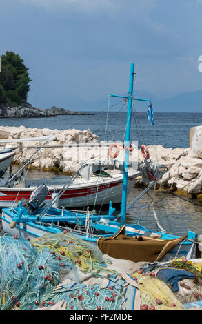 colourful greek fishing boats and nets in the harbour at Kassiopi on the greek island of corfu. Stock Photo