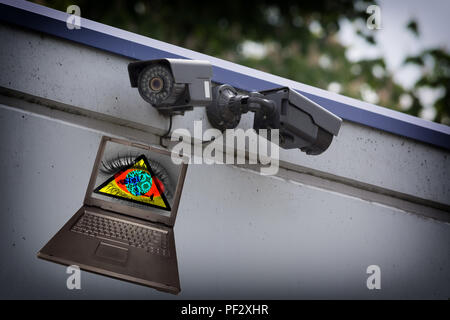 Two  CCTV or security camera with laptop and eye symbol on the monitor. Picture with vignette lens. Stock Photo