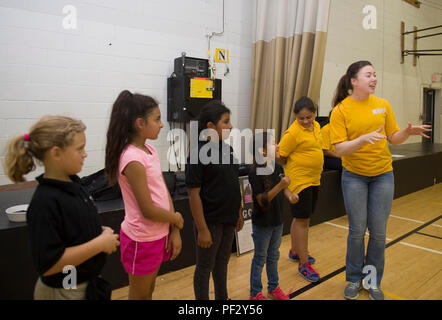 170919-N-KB426-253  OKLAHOMA CITY (Sept. 19, 2017) Seaman Sydney Donovan, assigned to the USS Constitution, right, plays dodge ball with students at the Santa Fe South Boys and Girls Club during a community relations event as part of Navy Week Oklahoma City. Navy Week programs serve as the principal outreach effort into areas of the country without a significant Navy presence, helping Americans understand that their Navy is deployed around the world, around the clock, ready to defend America at all times. (U.S. Navy photo by Mass Communication Specialist 2nd Class James Vazquez/Released) Stock Photo