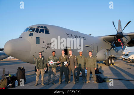 Members of the C-130J Super Hercules number 5833 delivery team pose for a photo, Dec. 21, 2017, at Yokota Air Base, Japan. This was the eighth C-130J delivered to Yokota as part of a fleet-wide redistribution of assets set in motion by Air Mobility Command; this aircraft came from a Lockheed Martin facility. (U.S. Air Force photo by Senior Airman Donald Hudson) Stock Photo
