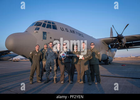 Members of the C-130J Super Hercules number 8605 delivery team pose for a photo, Dec. 21, 2017, at Yokota Air Base, Japan. Crewmembers from the 36th Airlift Squadron flew halfway around the world to deliver the aircraft from Ramstein Air Base, Germany. (U.S. Air Force photo by Senior Airman Donald Hudson) Stock Photo