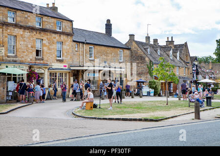 Broadway, UK - 8th August 2018: People enjoy summer day in Broadway, small town in the Cotswold district of Worcestershire,, England, which is often r Stock Photo