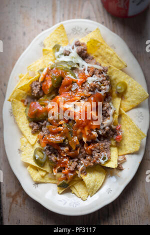 Chilli beef nachos with salsa, jalapeños & grated cheese Stock Photo