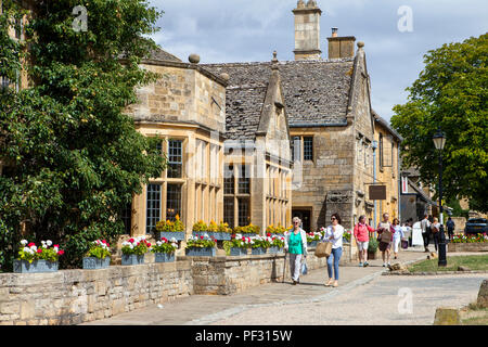 Broadway, UK - 8th August 2018: People enjoy summer day in Broadway, small town in the Cotswold district of Worcestershire,, England, which is often r Stock Photo
