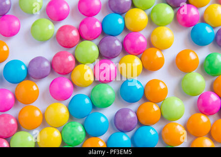 Pile of colorful sweet candy chocolates coated on white paper. colourful collection Stock Photo