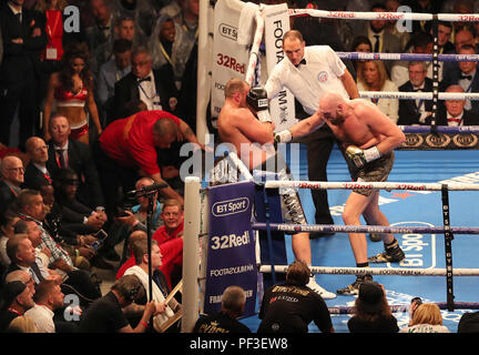 Tyson Fury (right) in action against Francesco Pianeta as Deontay Wilder (ringside, left) watches during the Heavyweight fight at Windsor Park, Belfast. Stock Photo