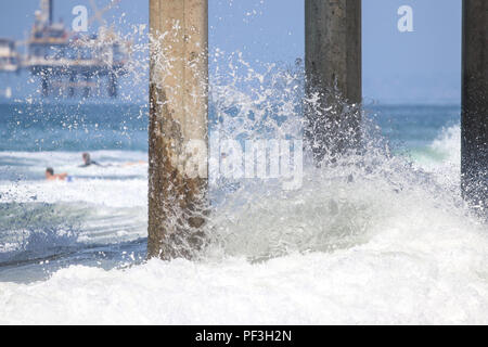 waves splashing on pier pilings Stock Photo