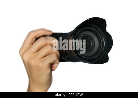 Photo camera in hand isolated on white background. Small size mirrorless camera with telephoto lens on white background. isolate Stock Photo