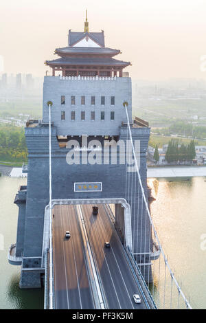 Yangzhou, Jiangsu, China.  Bridge Over River Liao Jia Gou.  Industrial Haze in the Distance, Late Afternoon. Stock Photo