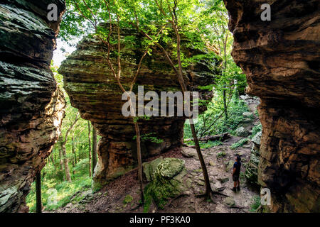 Person standing near massive sandstone rock formation - Indian Point Trail - Garden of the Gods, Shawnee National Forest, Illinois, USA Stock Photo