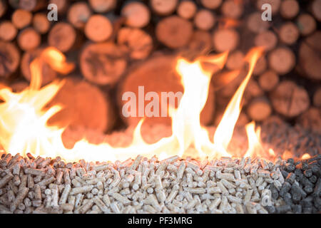 Wooden mass in fire - pellets and pile of wood Stock Photo