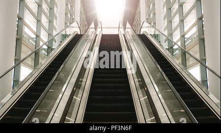 Escalator in a modern building. Empty bank of escalators leading out of a building. Stock Photo