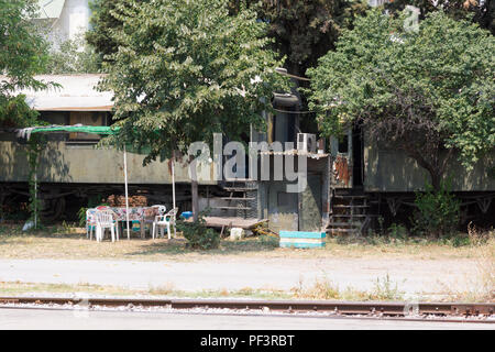 An abandoned train carriage being lived in, Thessaloniki, Greece Stock Photo