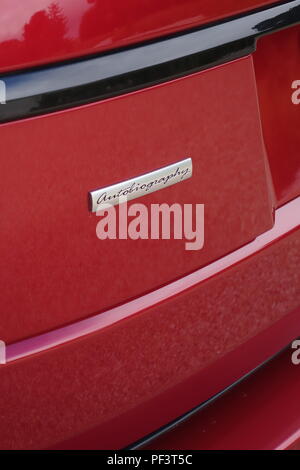 Range Rover Autobiography in Spectral Racing Red - ChromaFlair seen parked in old stone slab floored courtyard. Property released Stock Photo