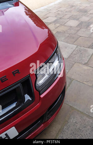 Range Rover Autobiography in Spectral Racing Red - ChromaFlair seen parked in old stone slab floored courtyard. Property released Stock Photo