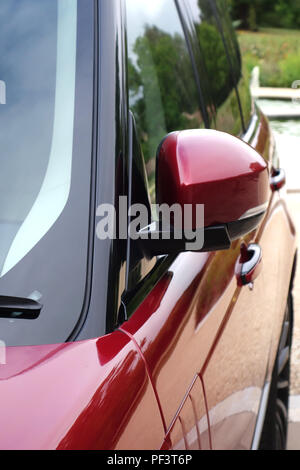 Range Rover Autobiography in Spectral Racing Red - ChromaFlair seen parked in old stone slab floored courtyard. Property released Stock Photo