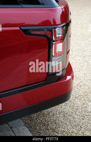 Range Rover Autobiography in Spectral Racing Red - ChromaFlair seen parked in old stone slab floored courtyard. Property released Stock Photo