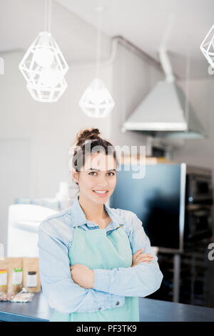 Smiling Waitress in Modern Cafe Stock Photo