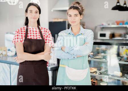 Two Waitresses Posing in Cafe Stock Photo