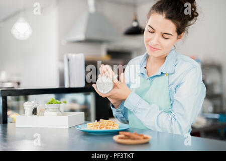 Waitress Finishing Dessert in Cafe Stock Photo