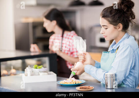 Woman Making Waffles in Cafe Stock Photo