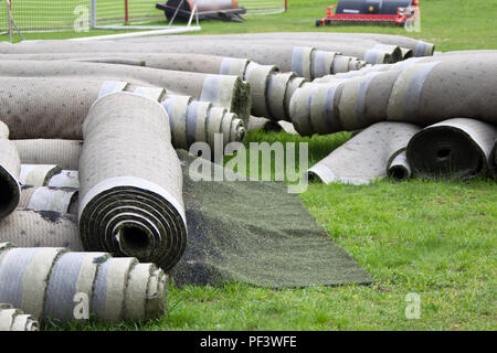Old artificial lawn twisted into rolls Stock Photo