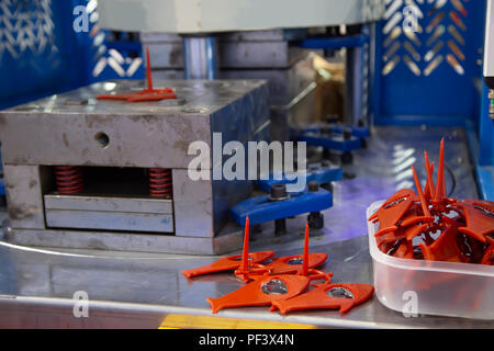 injection molding machine inject bottle cap opener Stock Photo