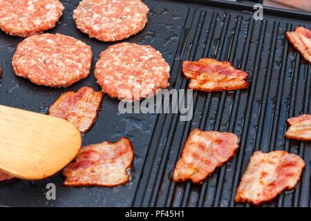 grilling chicken with spices on the electric grill in the home kitchen  Stock Photo - Alamy