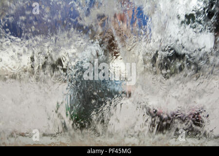 A woman pushing a pram - watery abstract background Stock Photo