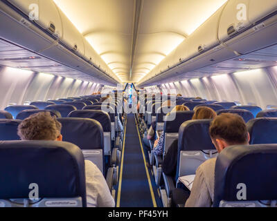 Saloon aircraft with passengers during the flight. Stock Photo