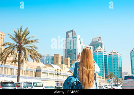 Woman taking mobile photo of the Central Souq (market) in Sharjah City, United Arab Emirates Stock Photo