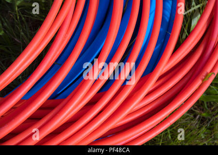 blue and orange fiber cables on a construction site Stock Photo
